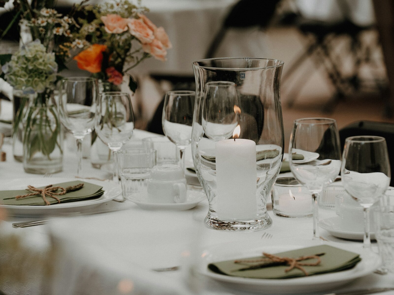 A garden table set with roses and greenery